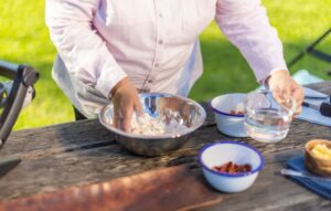 Dale Tilbrook Aboriginal woman making damper rolls with native quandong jam